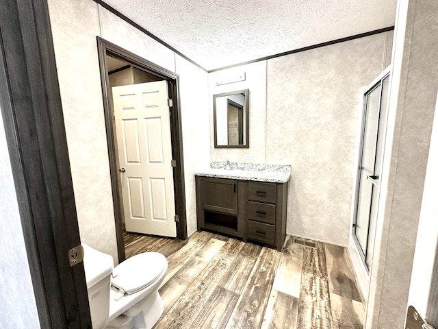 3502 Beech Ln, Twin Lake, MI 49457 - full bathroom featuring vanity, a shower stall, wood finished floors, ornamental molding, and a textured ceiling