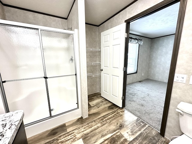 3502 Beech Ln, Twin Lake, MI 49457 - bathroom featuring wood finished floors, a stall shower, and ornamental molding