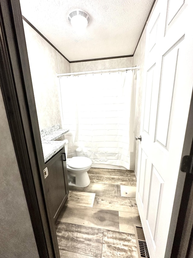 3502 Beech Ln, Twin Lake, MI 49457 - full bathroom featuring a textured ceiling, wood finished floors, a tile shower, and vanity