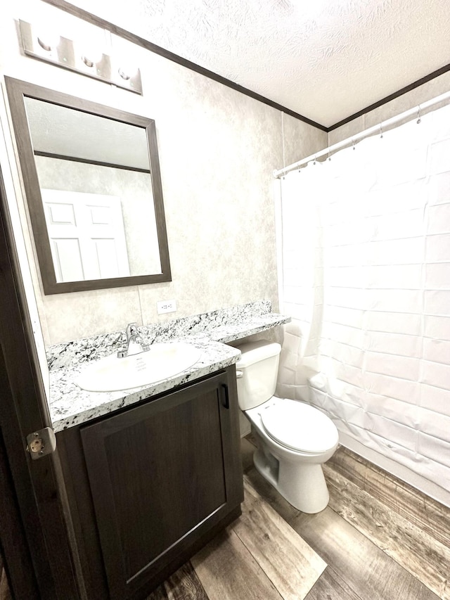 3502 Beech Ln, Twin Lake, MI 49457 - bathroom with a textured ceiling, vanity, wood finished floors, curtained shower, and crown molding