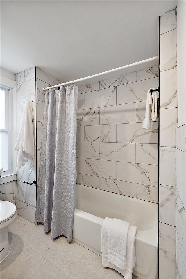 bathroom with shower / tub combo and toilet