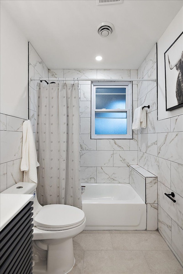 full bath with visible vents, toilet, shower / bathtub combination with curtain, and tile walls
