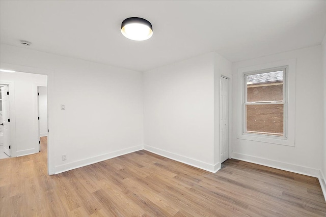 unfurnished room featuring light wood-style floors and baseboards