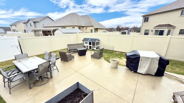view of patio featuring a fenced backyard, a residential view, area for grilling, and outdoor dining space