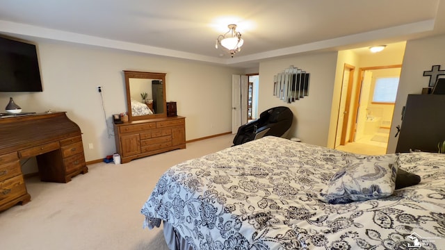 carpeted bedroom featuring baseboards and a raised ceiling