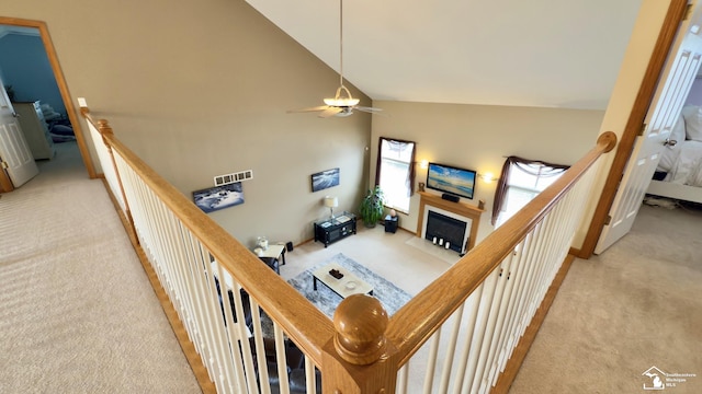 stairway featuring a fireplace, high vaulted ceiling, a ceiling fan, and carpet