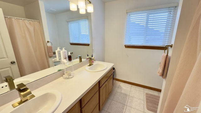 bathroom featuring plenty of natural light, tile patterned floors, and a sink