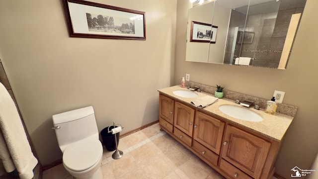 full bathroom with double vanity, a sink, toilet, and tiled shower