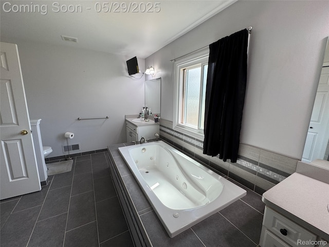 56098 Walker Ct, Macomb, MI 48042 - full bath with tile patterned floors, vanity, a whirlpool tub, and toilet