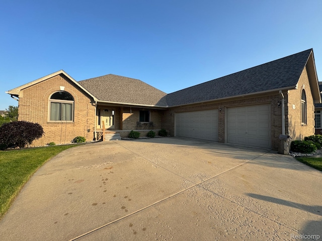 56098 Walker Ct, Macomb, MI 48042 - ranch-style house featuring brick siding, an attached garage, covered porch, concrete driveway, and a shingled roof