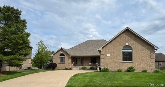 56098 Walker Ct, Macomb, MI 48042 - ranch-style home with a front yard and brick siding