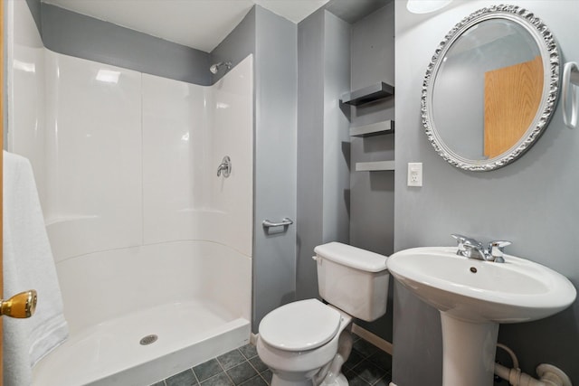 full bathroom with a stall shower, baseboards, toilet, and tile patterned flooring