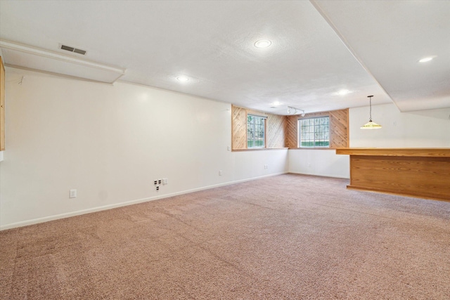 basement with carpet, baseboards, and visible vents