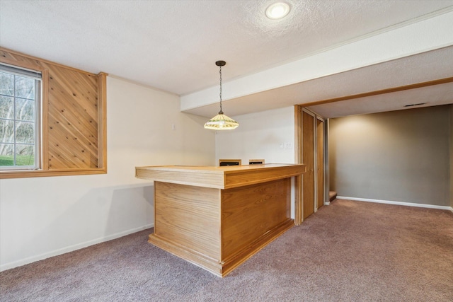 bar with a bar, carpet, baseboards, and a textured ceiling