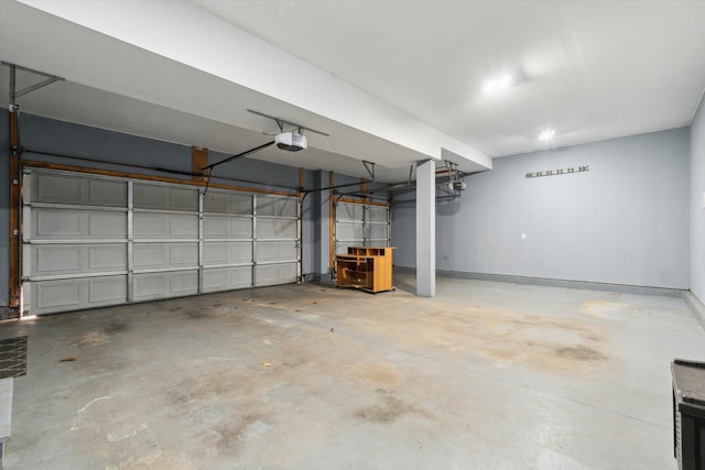 garage with baseboards and a garage door opener