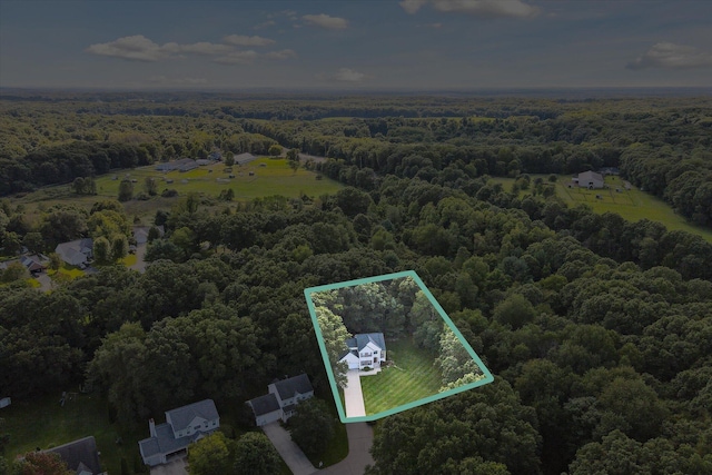 bird's eye view with a wooded view