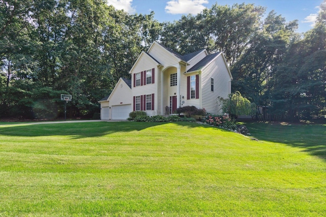 view of front of home with a front yard and an attached garage