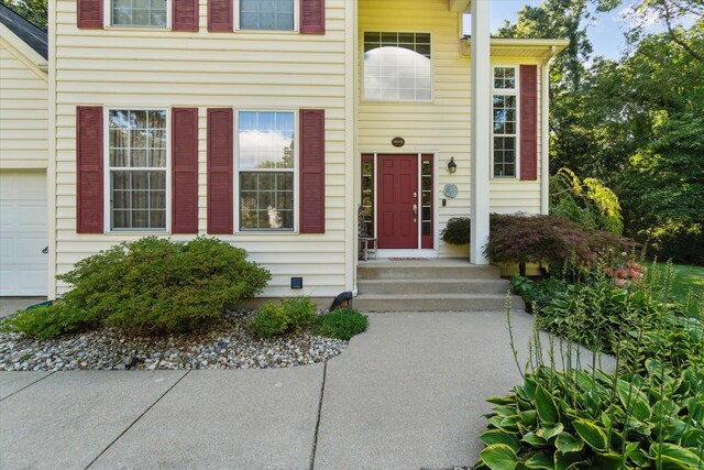 view of exterior entry with a garage