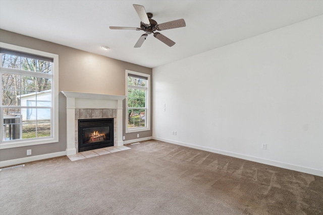 unfurnished living room featuring carpet flooring, plenty of natural light, and baseboards
