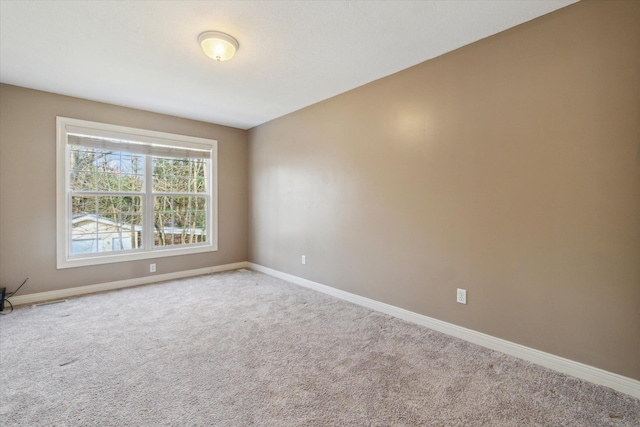 unfurnished room featuring baseboards and carpet floors
