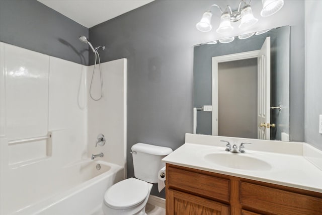 bathroom with toilet, vanity, and shower / washtub combination