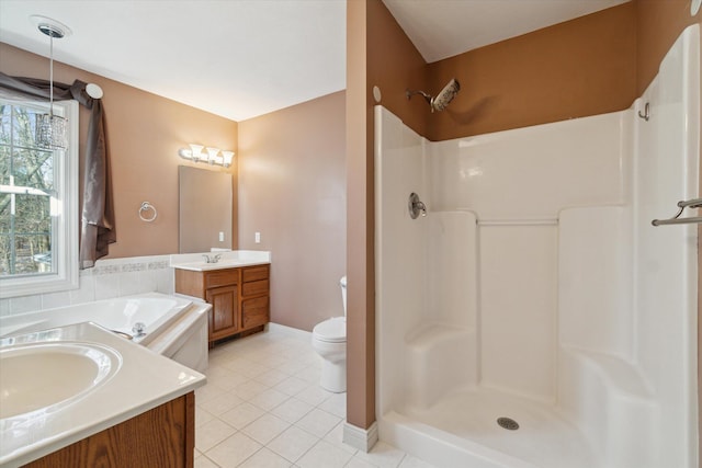 bathroom with walk in shower, baseboards, toilet, vanity, and tile patterned flooring