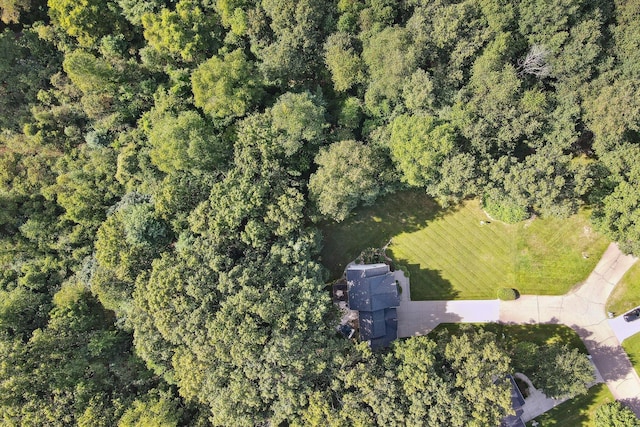 bird's eye view with a wooded view