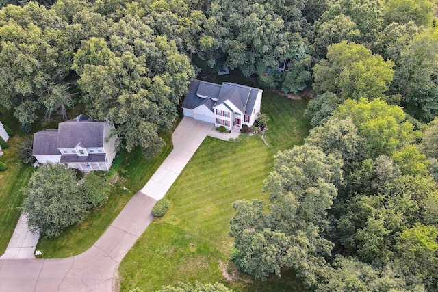 drone / aerial view featuring a wooded view
