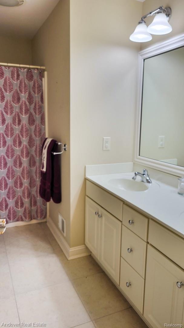 2004 Timberview Dr, Okemos, MI 48864 - bathroom featuring double vanity, tile patterned floors, baseboards, and a shower with curtain