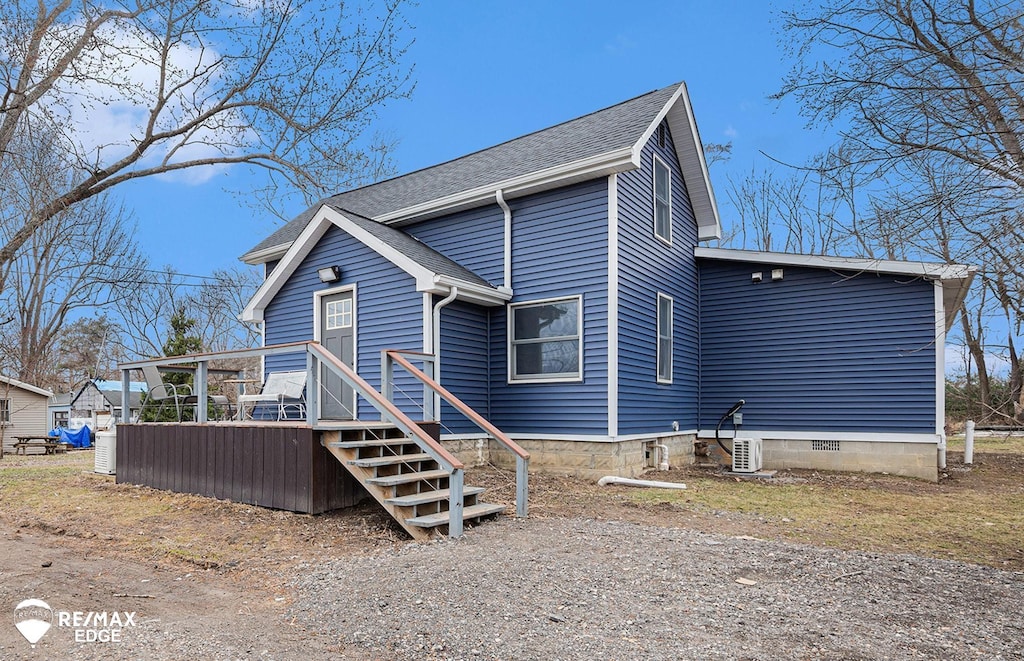 view of property exterior with a wooden deck