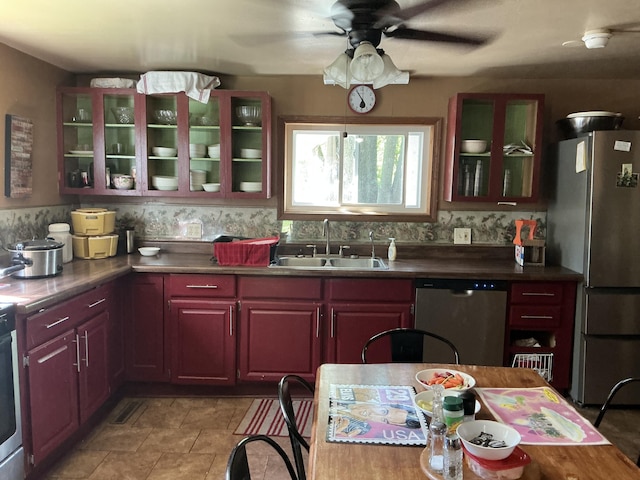 121 W State St, Reading, MI 49274 - kitchen with appliances with stainless steel finishes, a sink, a ceiling fan, and glass insert cabinets