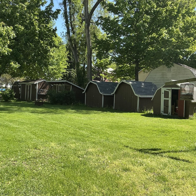 121 W State St, Reading, MI 49274 - view of green lawn featuring a shed and an outbuilding