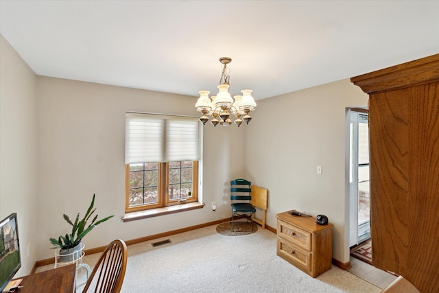 carpeted office with an inviting chandelier, baseboards, and visible vents
