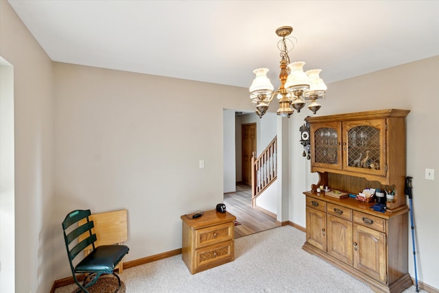interior space with an inviting chandelier, baseboards, light carpet, and stairs