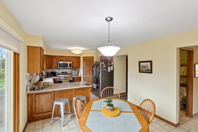 dining space featuring baseboards