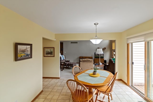 dining area with light tile patterned flooring, visible vents, and a wealth of natural light