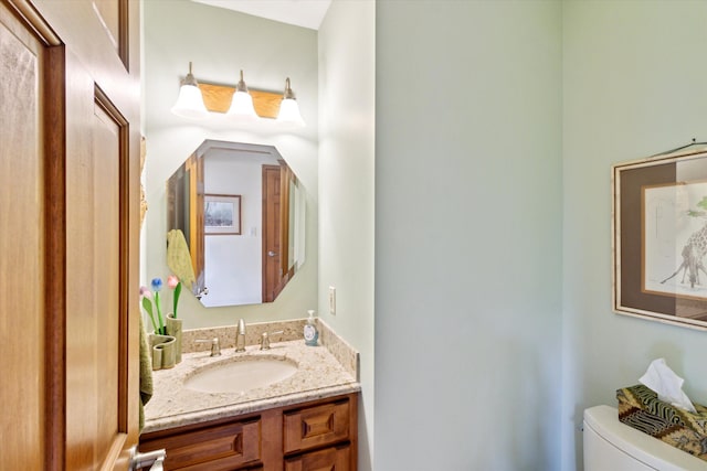 half bathroom with vanity and toilet