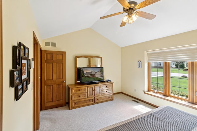 bedroom featuring a ceiling fan, vaulted ceiling, light colored carpet, and visible vents