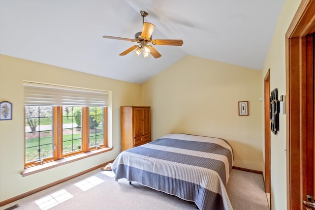 bedroom with baseboards, a ceiling fan, carpet, and vaulted ceiling