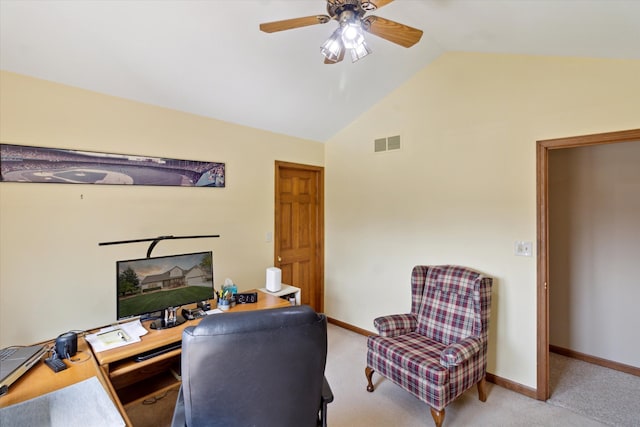 office featuring a ceiling fan, visible vents, light colored carpet, baseboards, and lofted ceiling