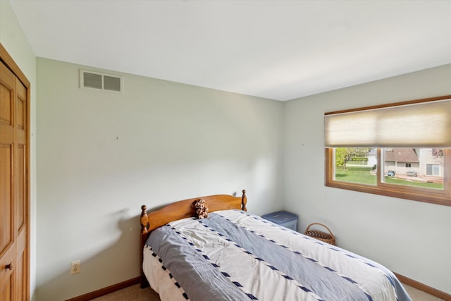 bedroom featuring baseboards, carpet flooring, and visible vents