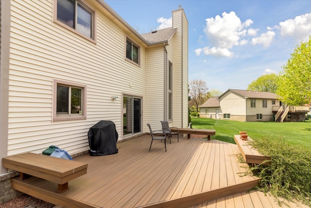 deck featuring a yard and a grill