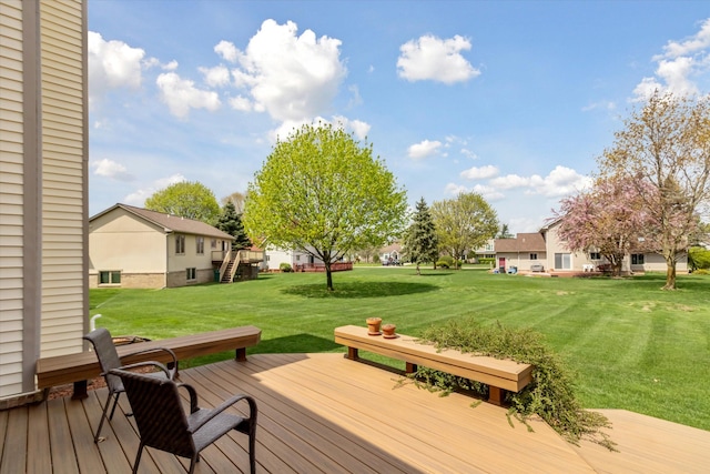 deck featuring a residential view and a yard