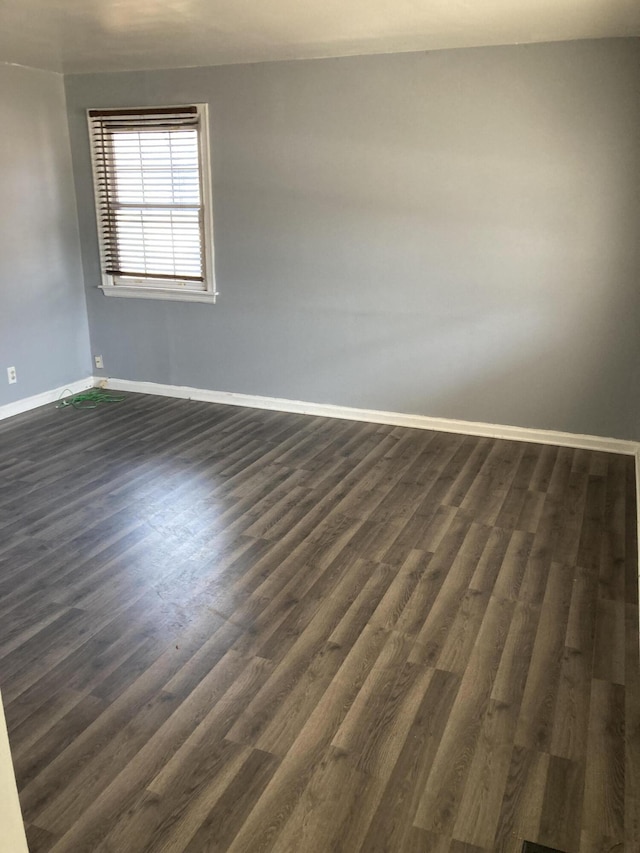 3309 Temple St, Muskegon, MI 49444 - spare room with baseboards and dark wood-style flooring