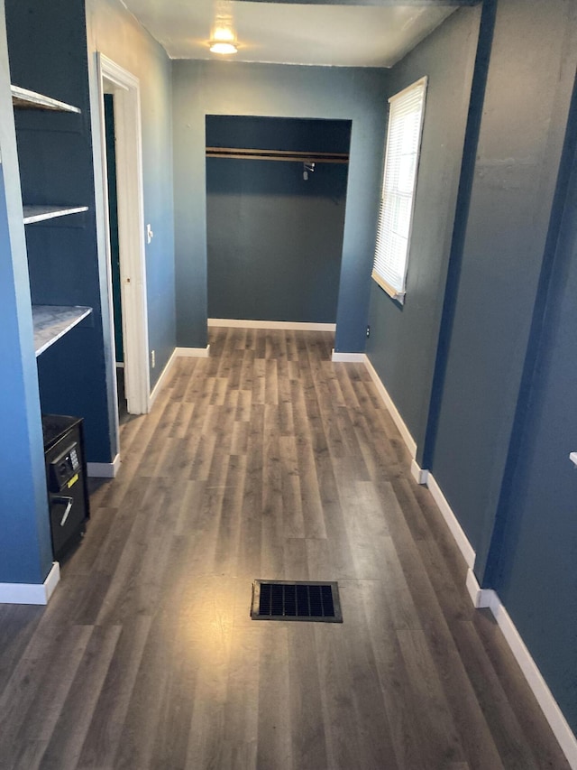 3309 Temple St, Muskegon, MI 49444 - unfurnished bedroom with dark wood finished floors, a closet, baseboards, and visible vents