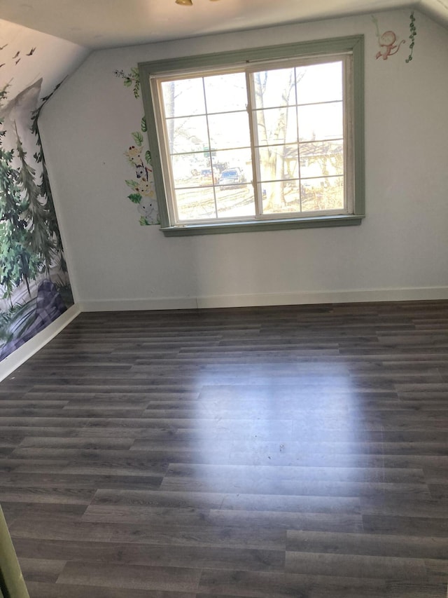 3309 Temple St, Muskegon, MI 49444 - spare room with baseboards, lofted ceiling, and dark wood finished floors