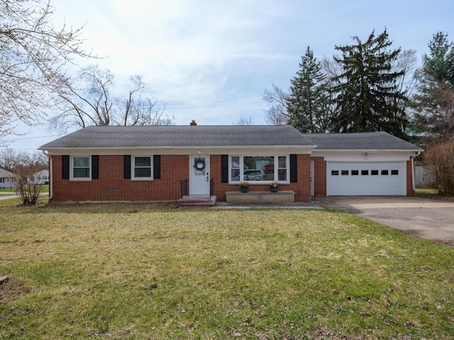 ranch-style home with brick siding, driveway, a garage, and a front lawn