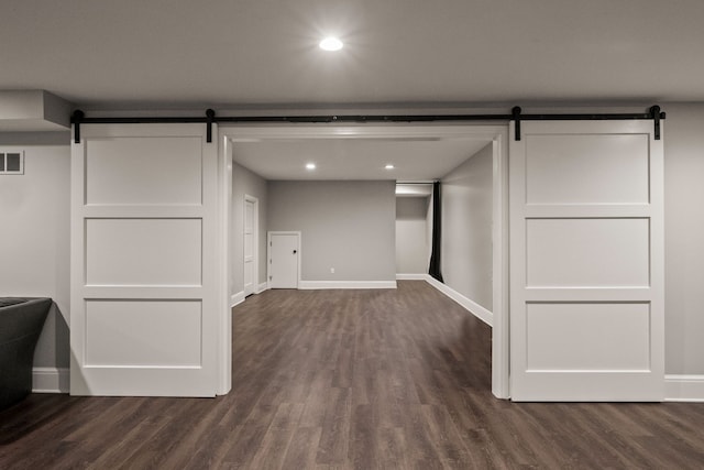 1044 Lakeside Dr, Birmingham, MI 48009 - below grade area featuring dark wood-type flooring, baseboards, and a barn door