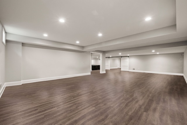 1044 Lakeside Dr, Birmingham, MI 48009 - finished below grade area with recessed lighting, baseboards, dark wood finished floors, and a barn door