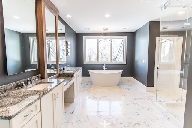 1044 Lakeside Dr, Birmingham, MI 48009 - bathroom featuring a stall shower, a freestanding tub, a sink, and baseboards